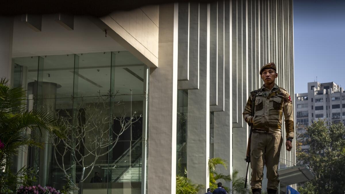 An armed security person stands guard at the gate of a building housing BBC office in New Delhi, India, on Wednesday, February 15, 2023. — AP