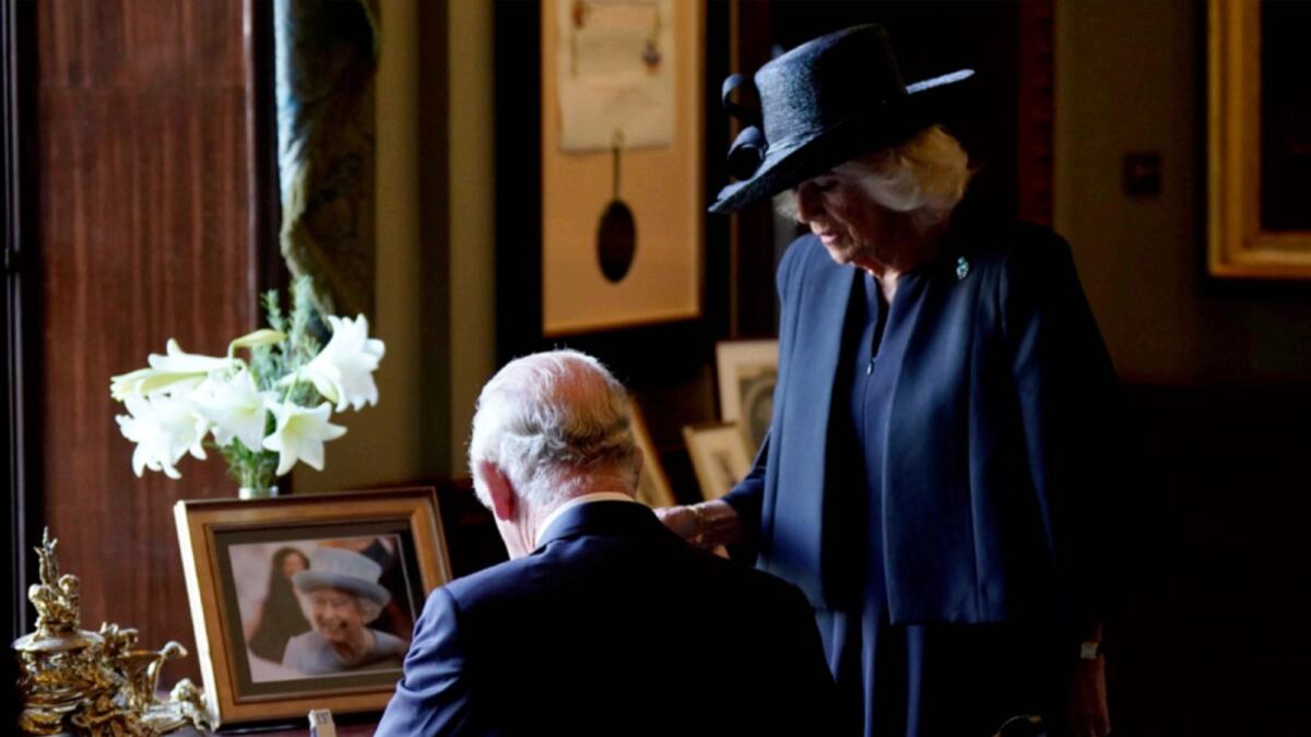 King Charles III and Camilla sign the visitors book during a visit to Hillsborough Castle. — AP