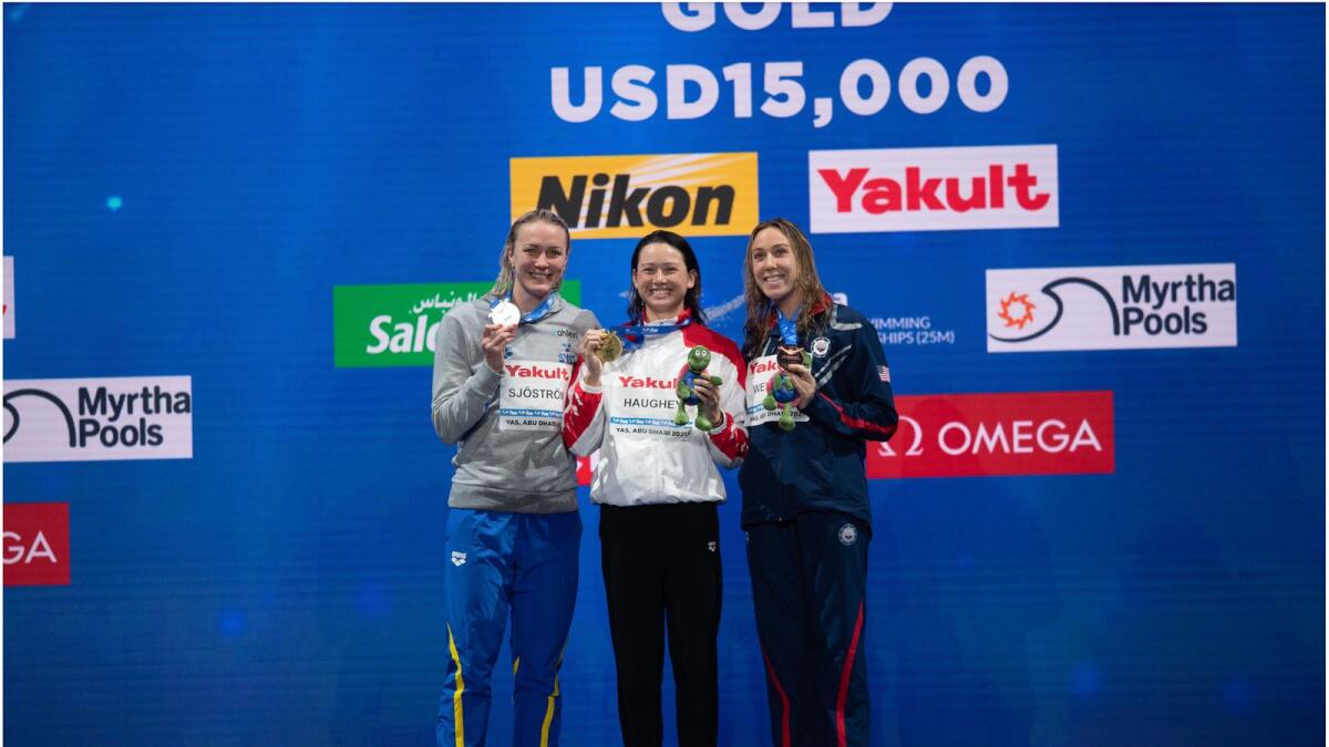 Siobhan Haughey (centre) celebrates on the podium at the FinaWorld Championships in Abu Dhabi. (Supplied photo)