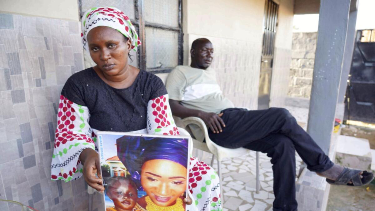 Mariama Kuyateh holds up a picture of her late son Musawho died from acute kidney failure, in Banjul. — AFP
