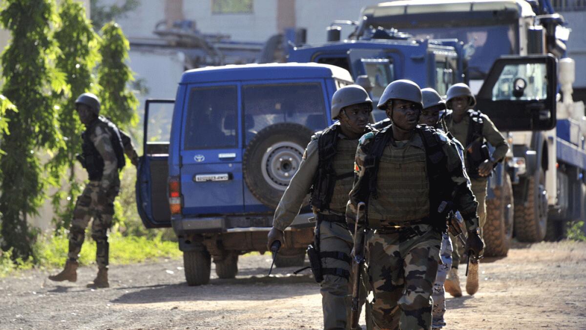 Malian troops take position near the Radisson Blu hotel in Bamako.