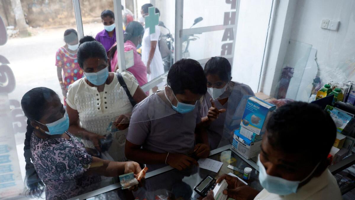 Customers stand in line to buy medicine at a pharmacy near Apeksha Hospital, Colombo, Sri Lanka, August 16, 2022.  — Reutes file