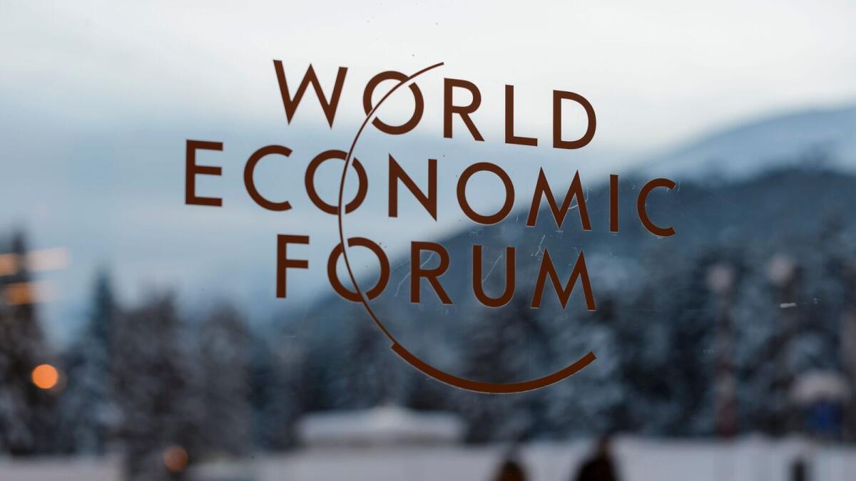 The logo of the World Economic Forum (WEF) is seen on window pane at the Congress Center prior to the forum's annual meeting in Davos.