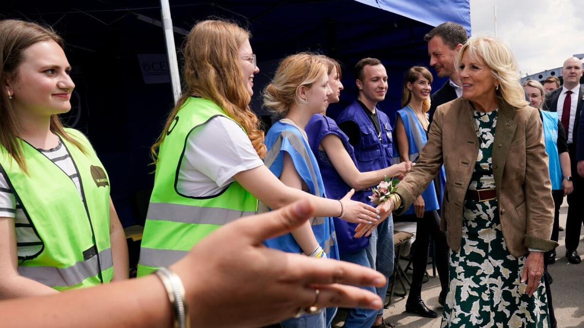 US First Lady Jill Biden greets volunteers and first responders next to Slovakia's Prime Minister Eduard Heger in Vysne Nemecke, Slovakia, near the border with Ukraine on May 8, 2022. AFP