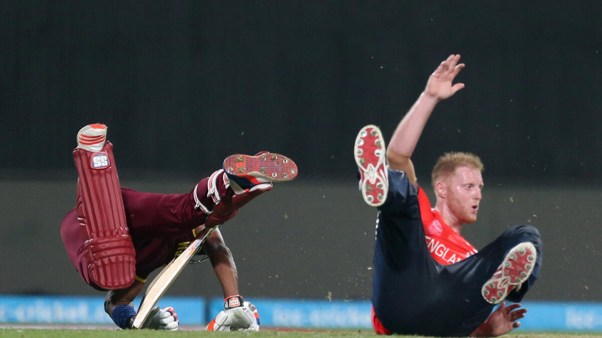 West Indies Dwayne Bravo, left, and  England's Ben Stokes collide during the final of the ICC World Twenty20 2016 cricket tournament at Eden Gardens in Kolkata, India, Sunday, April 3, 2016.