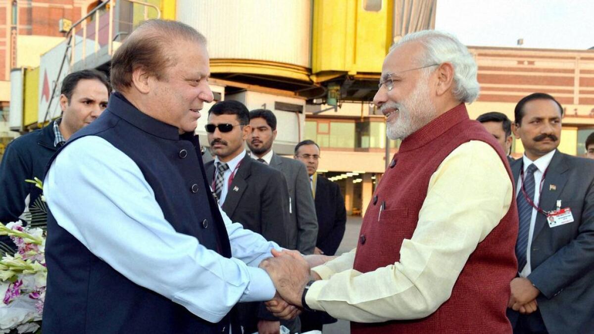 Indian Prime Minister, Narendra Modi (R) shakes hands with Pakistan Prime Minister, Nawaz Sharif in Lahore.  