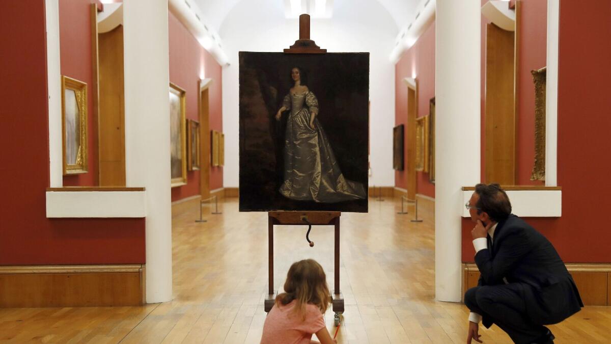 Eight year old Stella and Alex Farquharson Director Tate Britain pose with 'Portrait of an Unknown Lady' by Joan Carlile at Tate Britain in London, Britain September 21, 2016. Reuters