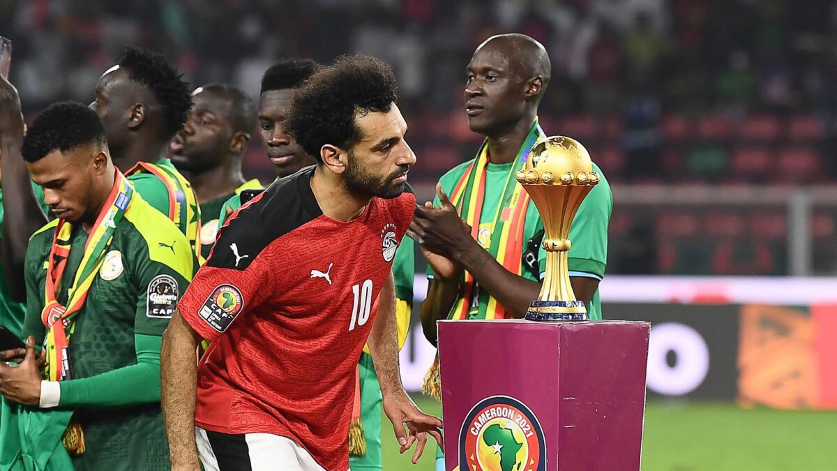 Egyptian forward Mohamed Salah walks past the trophy after losing the African Cup of Nations final against Senegal. — AFP