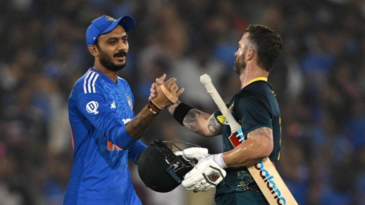 Australia's captain Matthew Wade (R) congratulates Axar Patel at the end of the fourth Twenty20 international cricket match on Friday. -  AFP