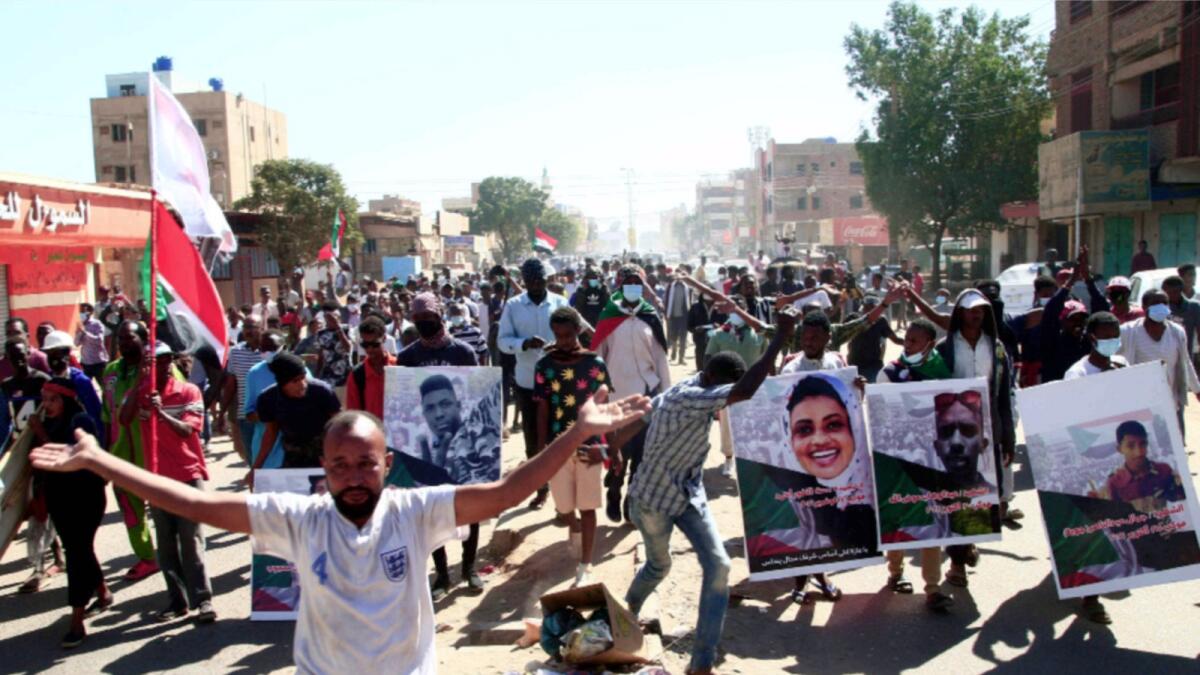 Sudanese demonstrators carry posters of killed protesters as they protest in the capital Khartoum against the army's October 25 coup. — AFP