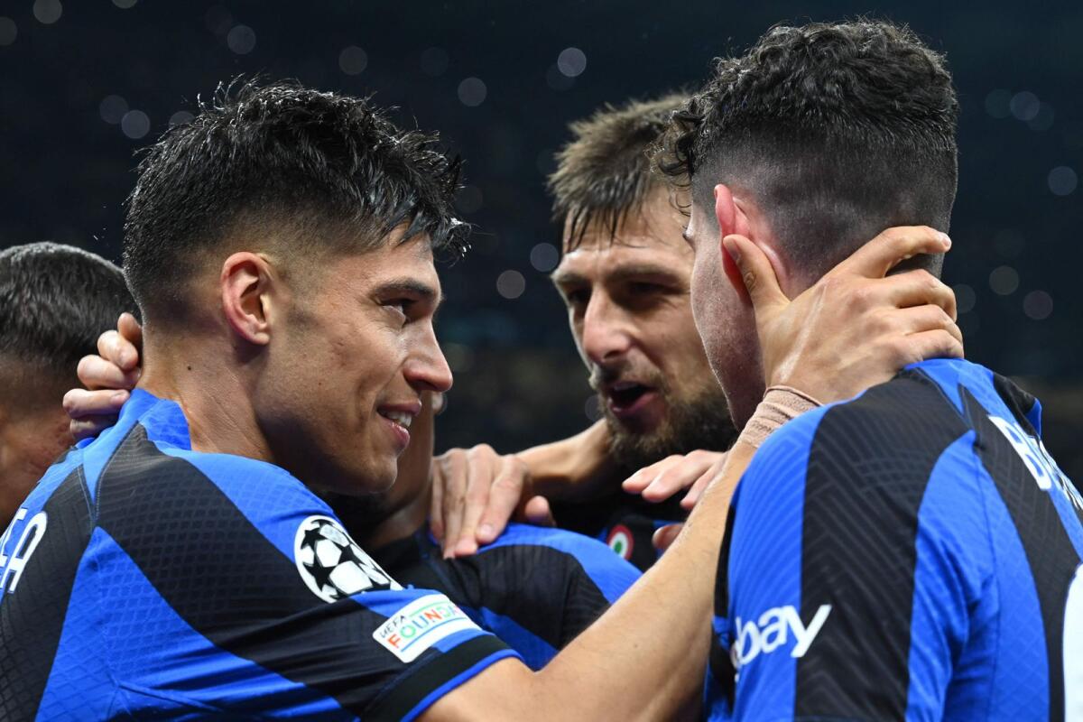 Inter Milan forward Joaquin Correa (left) celebrates with Francesco Acerbi (centre) and Alessandro Bastoni after scoring his side's third goal. — AFP