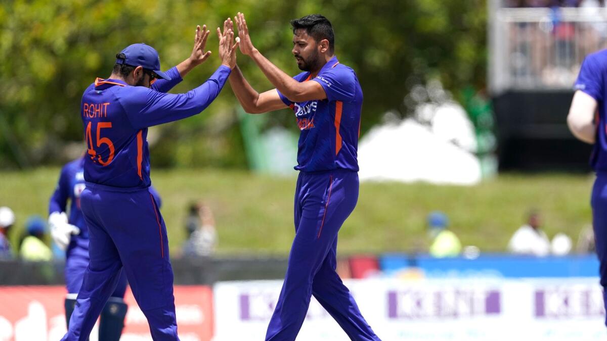 India's Avesh Khan (right) celebrates with captain Rohit Sharma after dismissing West Indies' Brandon King during the fourth T20I in Lauderhill on Saturday. — AP