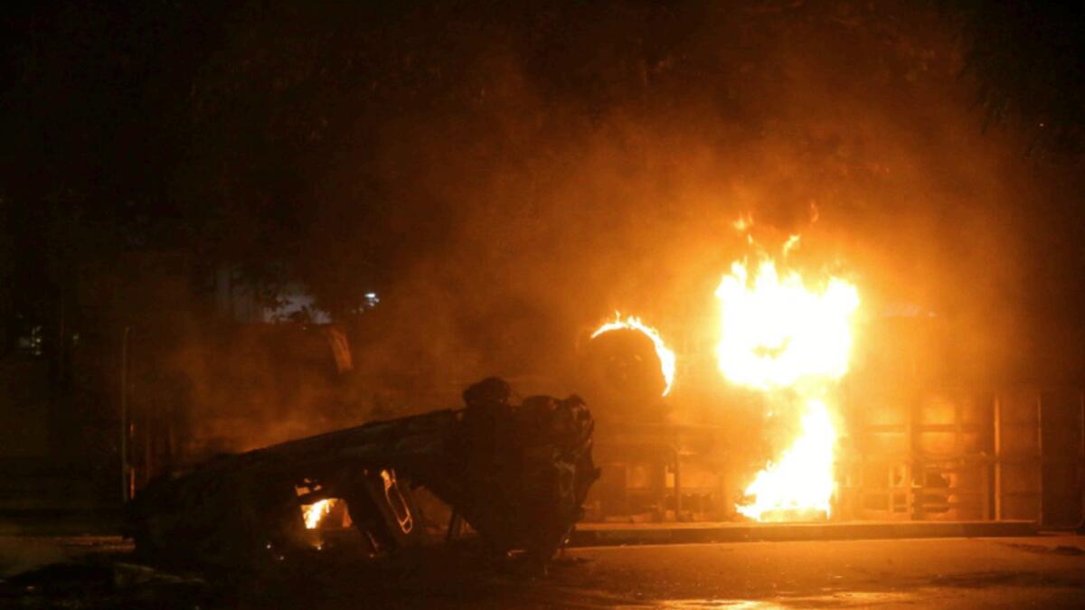 Vehicles of Sri Lanka's ruling party supporters burn after set on fire during a clash with anti-government demonstrators. — Reuters