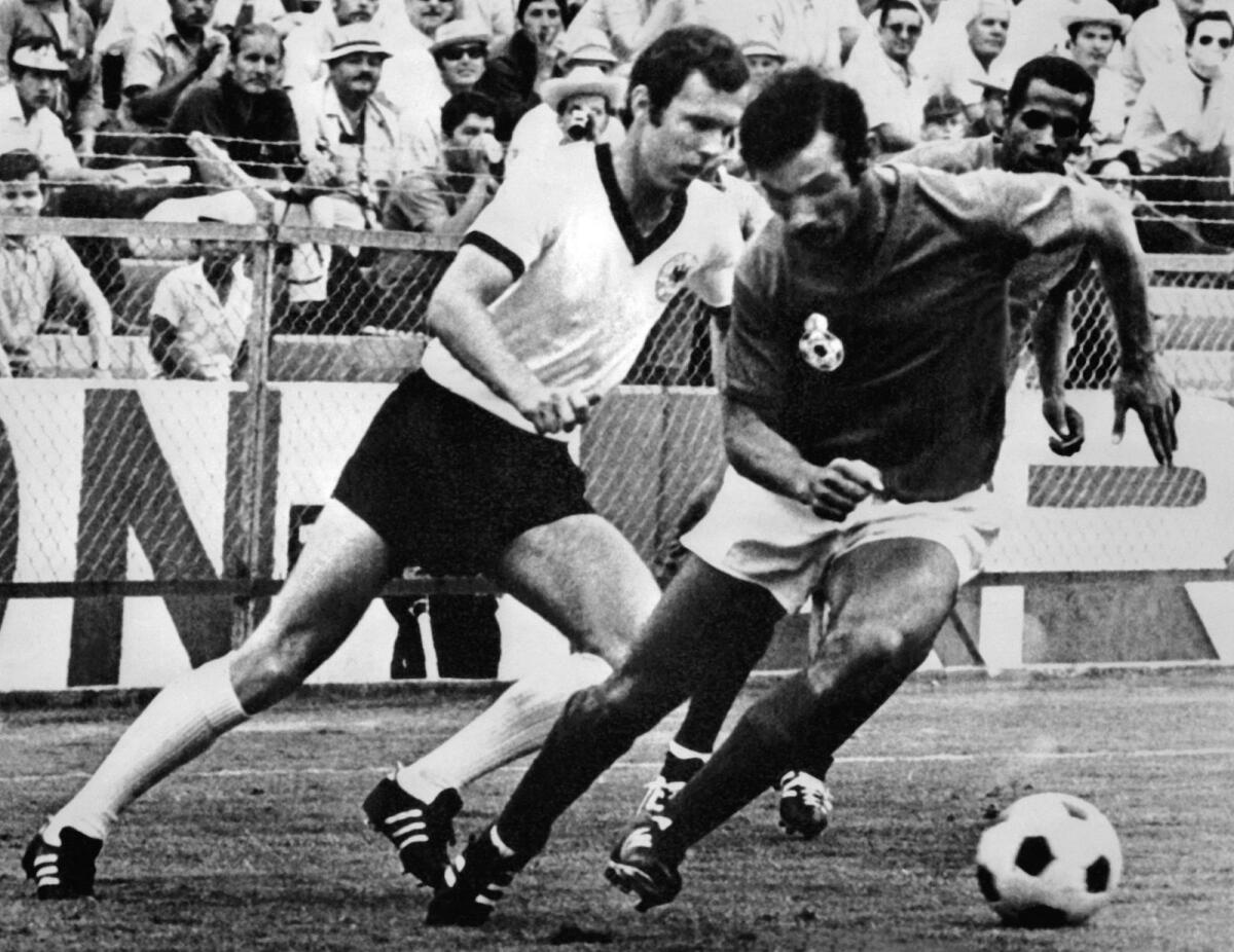 Franz Beckenbauer (left) fights for the ball with Moroccan Benkhrif Boujemaa during the 1970 World Cup. — AFP