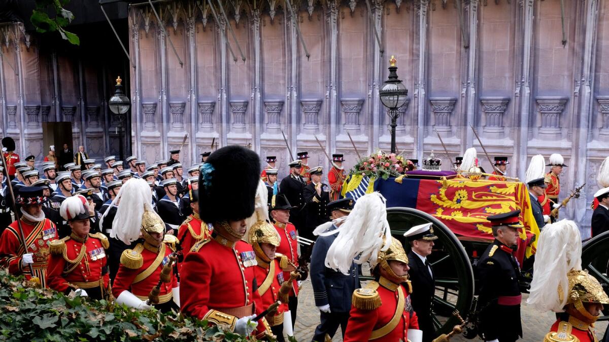 The Queen's coffin is carried by state funeral gun carriage from Westminster Hall to the abbey.