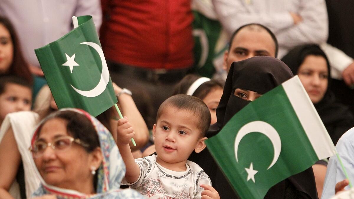 People of all ages gathered at the Pakistani consulate, holding national flags, to celebrate the spirit of Independence Day. (M. Sajjad/KT)