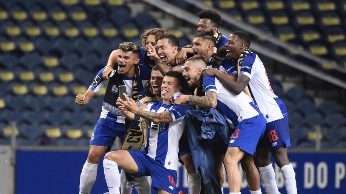 FC Porto players celebrate clinching their 29th Portuguese Primeira Liga title at the end of the Portuguese League football match between FC Porto and Sporting Portugal at the Dragao stadium in Porto. Photo: AFP