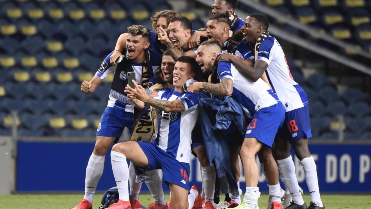 FC Porto players celebrate clinching their 29th Portuguese Primeira Liga title at the end of the Portuguese League football match between FC Porto and Sporting Portugal at the Dragao stadium in Porto. Photo: AFP