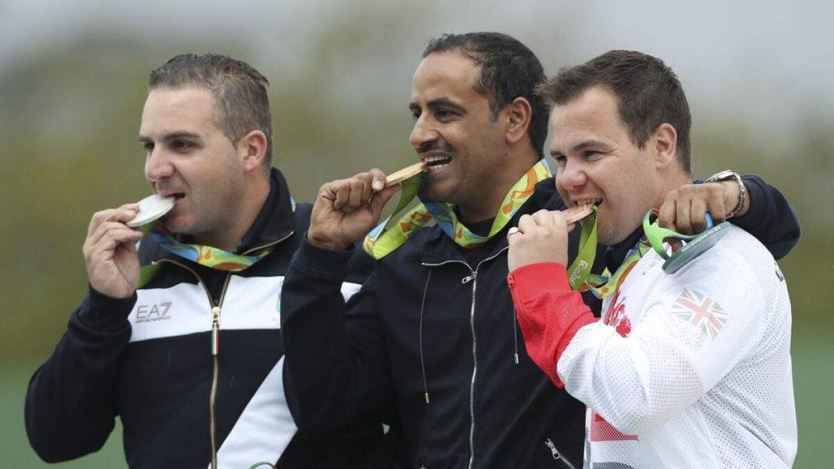 Gold medalist Fehaid Aldeehani, center, an independent athlete from Kuwait competing on the Refugee Olympic Team, is flanked by silver medalist Marco Innocenti, left, of Italy and Steven Scott, right, of Britain during the award ceremony