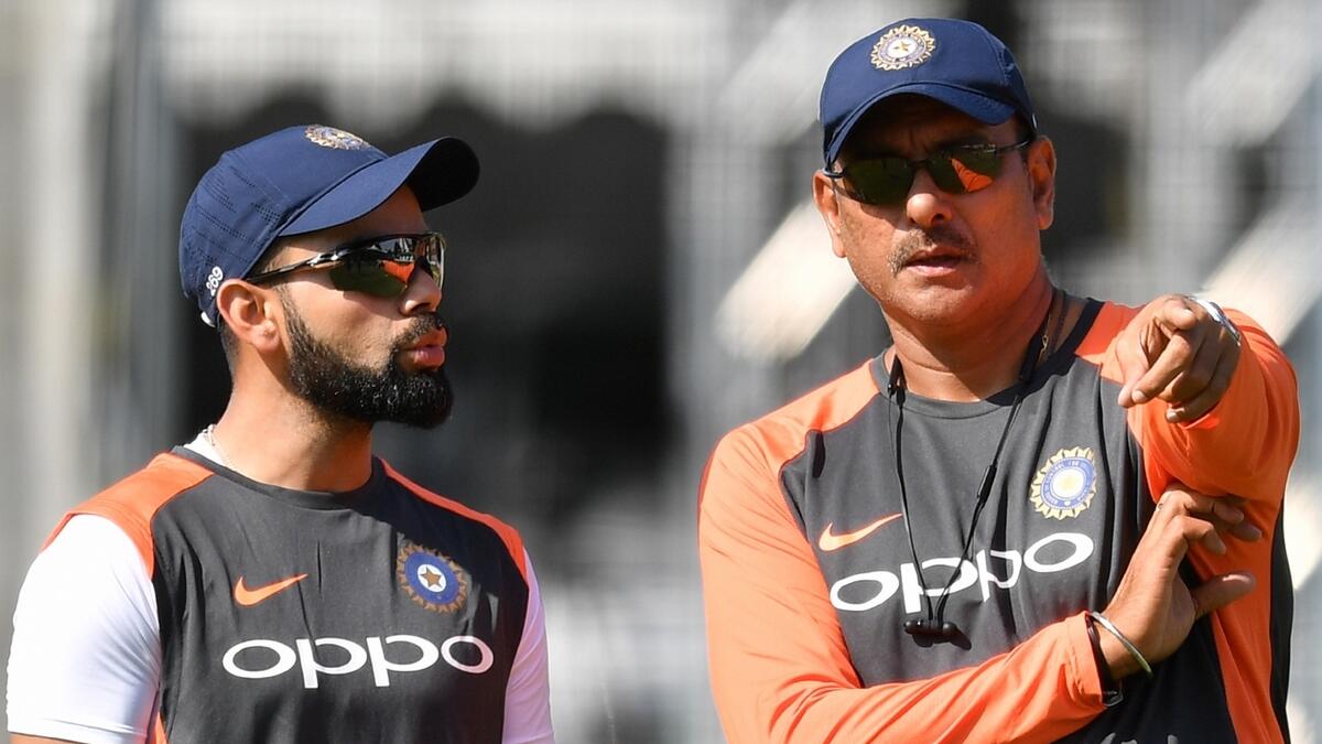 According to the head coach Ravi Shastri (right), when a player like Kohli sets such high standards, it rubs off on others. - AFP