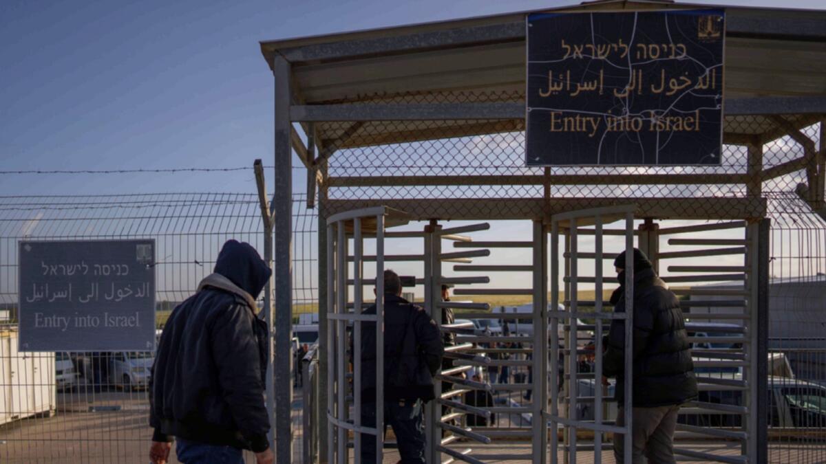 Palestinian workers enter Israel after crossing from Gaza on the Israeli side of Erez crossing between Israel and the Gaza Strip. — AP file