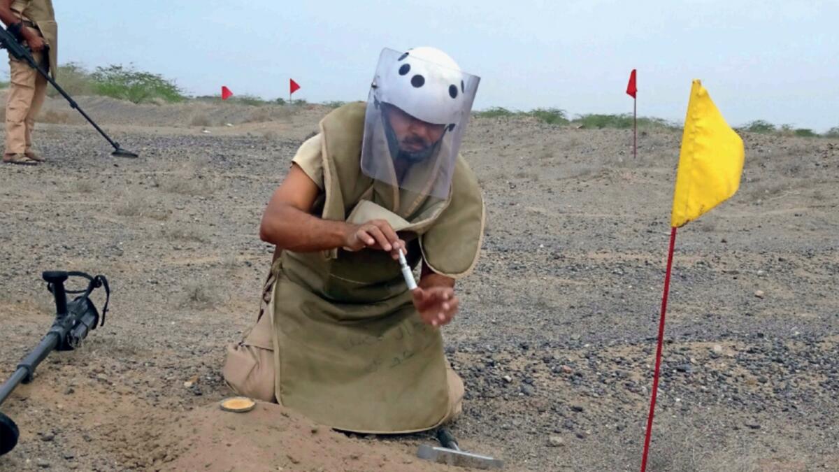 Members of Yemen's pro-government forces search for land mines in the western province of Hodeida. — AFP file