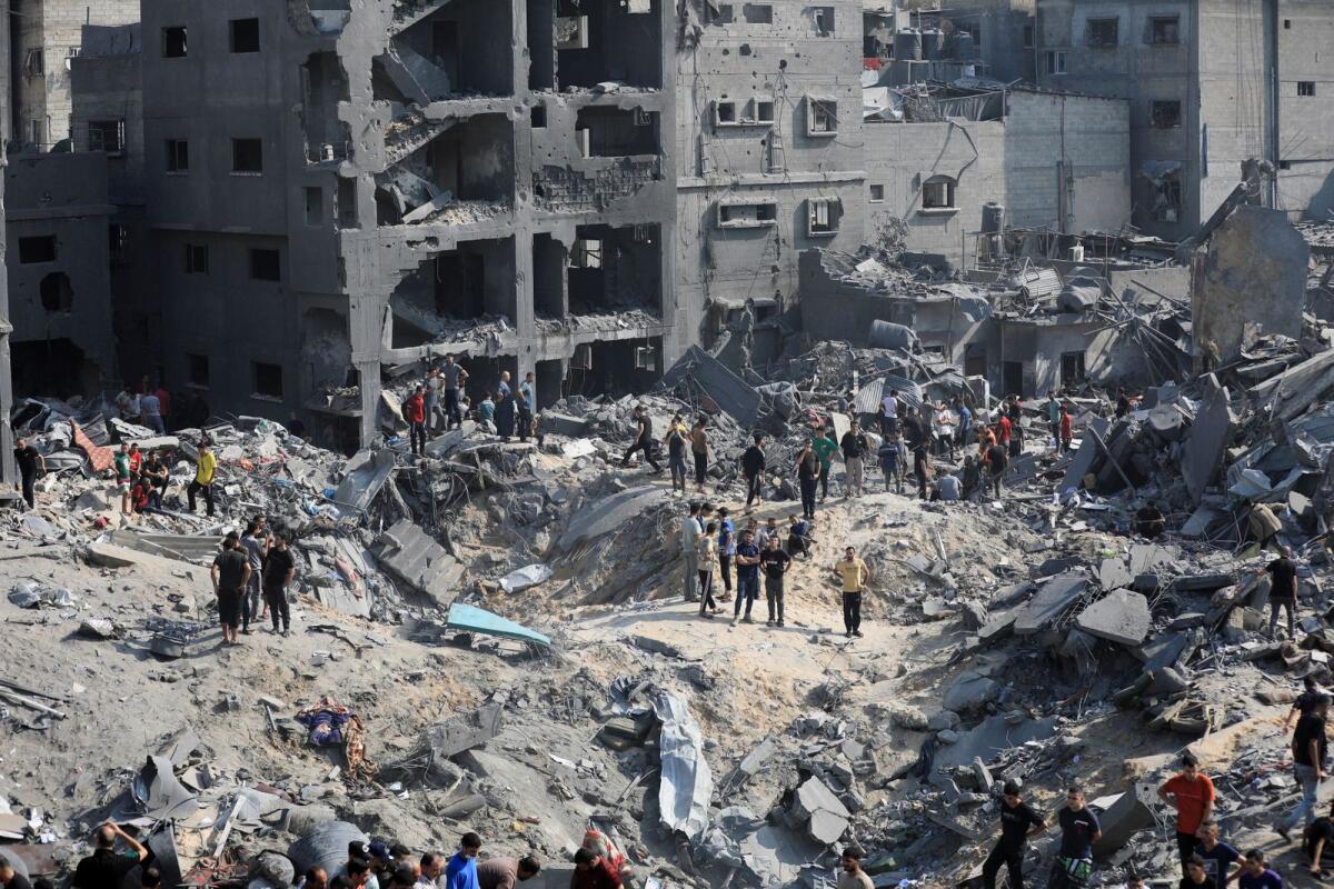 Palestinians search for casualties a day after Israeli strikes on houses in Jabalia refugee camp in the northern Gaza Strip on Wednesday. — Reuters