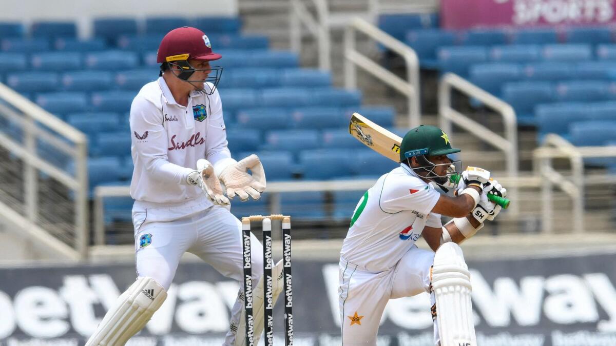 Abid Ali (right) of Pakistan hits a four as Joshua de Silva of West Indies watches on during day three of the first Test. — AFP
