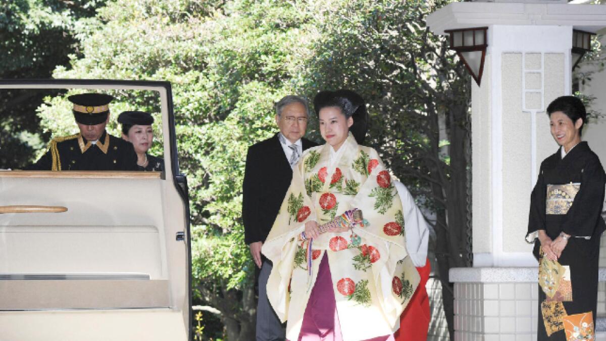 Japanese Princess Ayako dressed in a traditional ceremonial gown, and Japanese businessman Kei Moriya arrive at Meiji Shrine for their wedding ceremony in Tokyo
