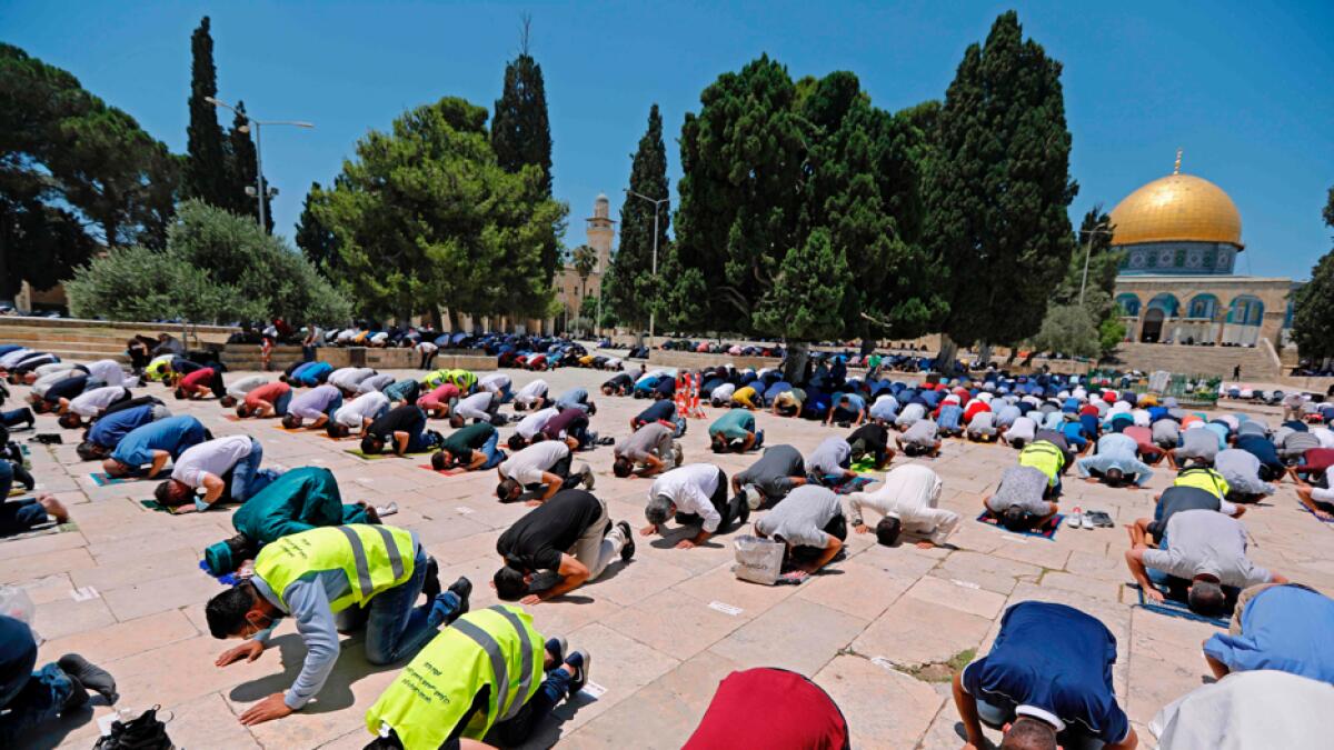 Palestinian Muslims perform Friday prayers outside the Dome of the Rock Mosque, in Jerusalem's Al-Aqsa mosques compound. Photo: AFP