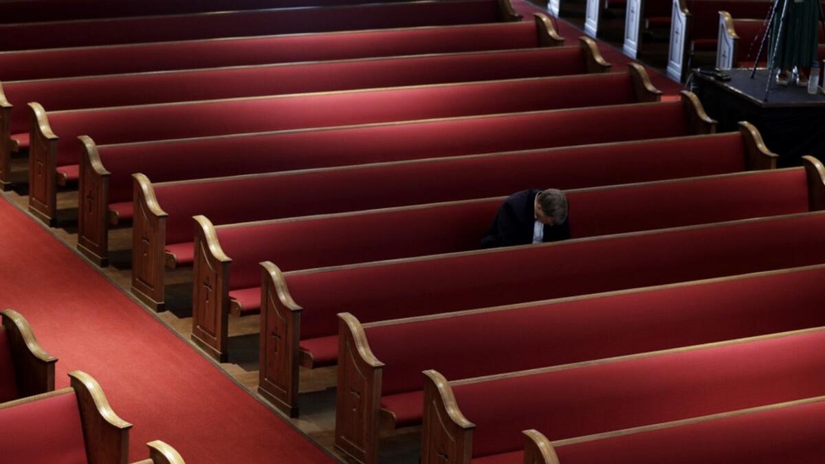 A man prays while attending an Easter service at Trinity Baptist Church in San Antonio, Sunday. Photo: AP