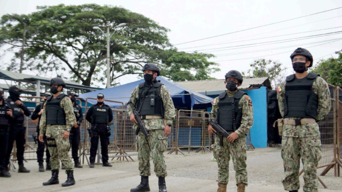 Military police stand guard outside the Guayas 1 prison after a violence outburst between the inmates that left 58 deaths in Guayaquil. — AFP