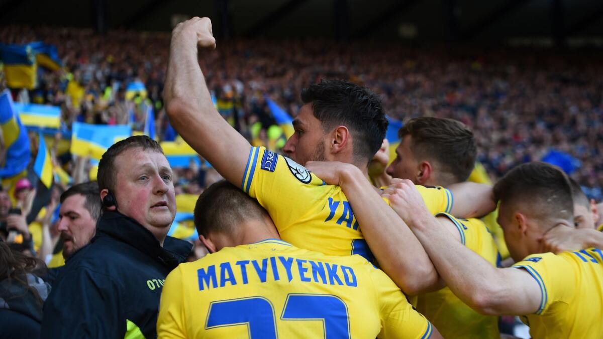 Ukraine's striker Roman Yaremchuk (centre) celebrates after scoring the team's second goal. (AFP)