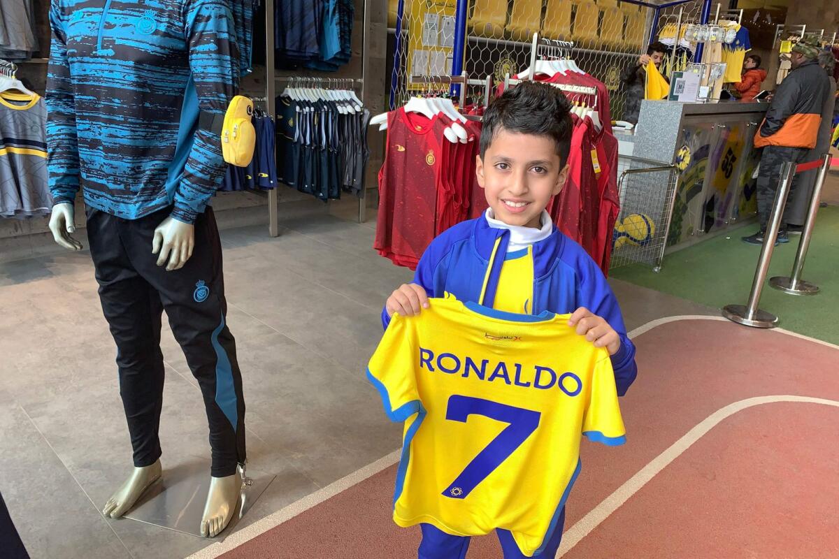 A young fan holds a t-shirt bearing the name Ronaldo in Ryadh. — AFP