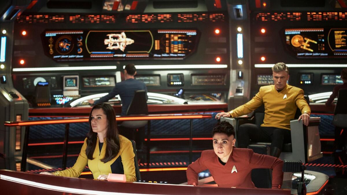 Rebecca Romijn as Una, left, Melissa Navia as Ortegas and Anson Mount as Pike in a scene from the series Star Trek: Strange New Worlds.