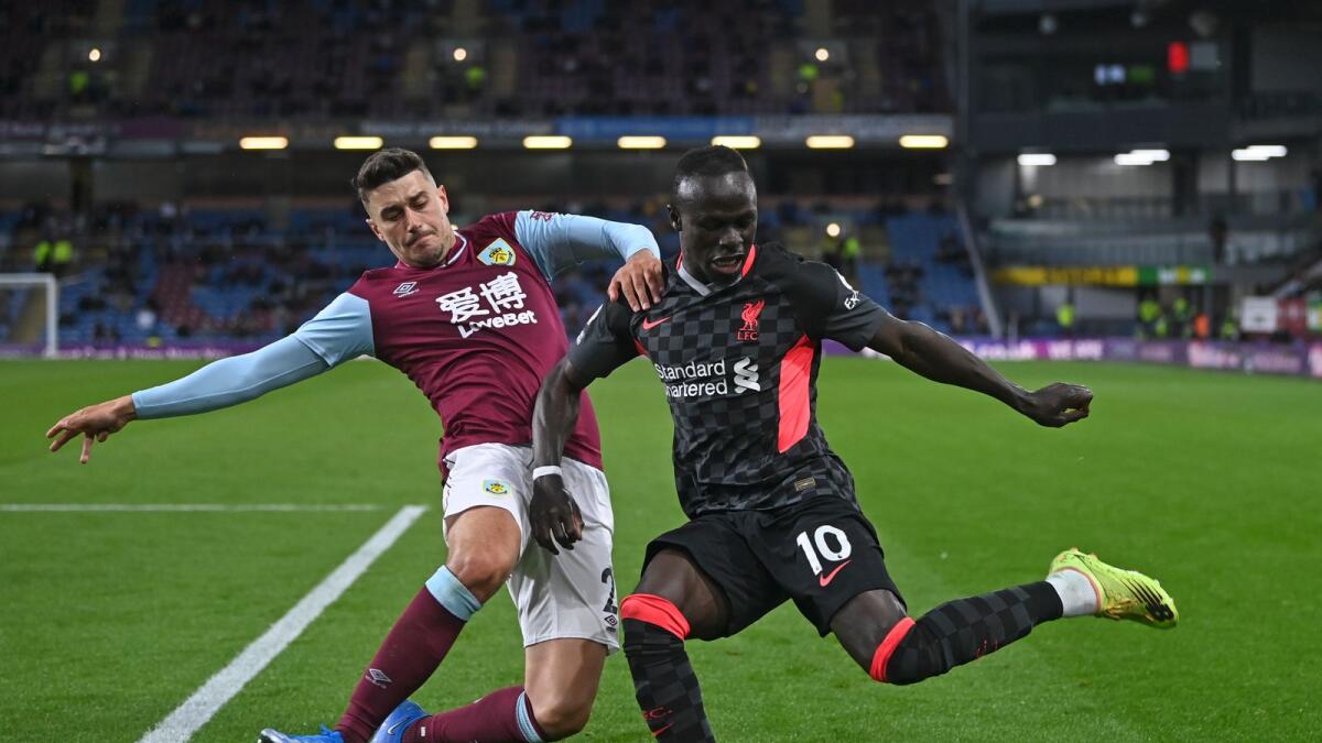 Burnley's Matthew Lowton challenges Liverpool’s Sadio Mane. (AP)