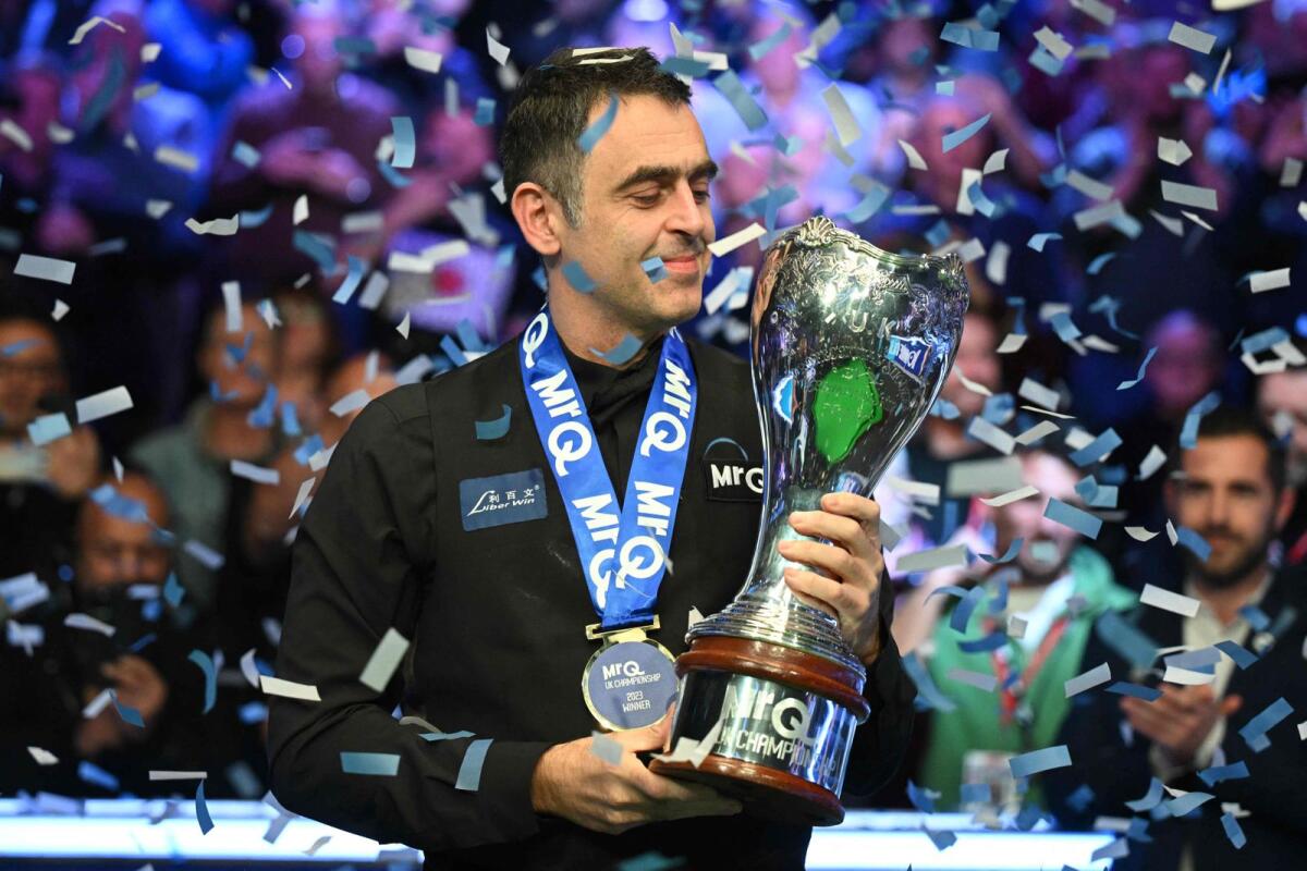 Ronnie O'Sullivan poses with the trophy. — AFP