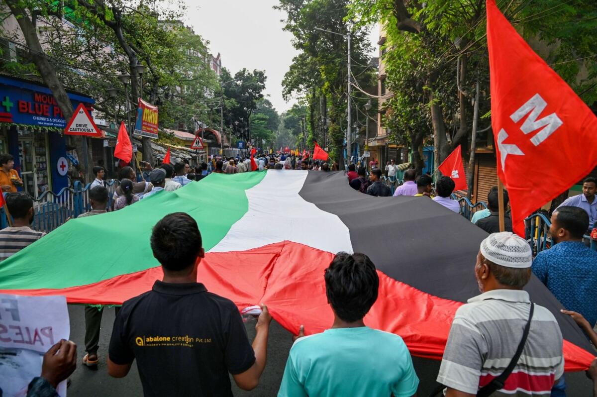 Members of CPI (M-L) New Democracy with other various organisations holding Palestine's flag participate in a rally to express their solidarity with Palestinians in Kolkata, India, on November 7, 2023. Photo: PTI