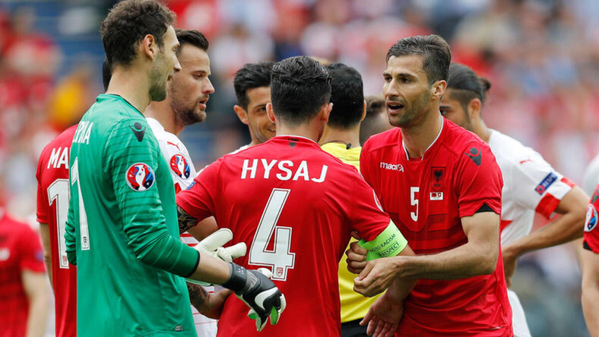 Albania's Lorik Cana gives the captains armband to Albania's Elseid Hysaj after being sent off. (Reuters)