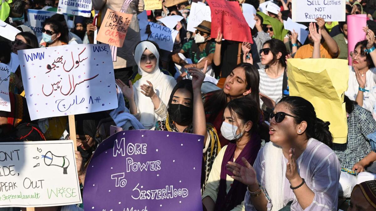 Activists of Aurat March hold placards during a rally to mark the International Women's Day in Lahore on Wednesday. — AFP