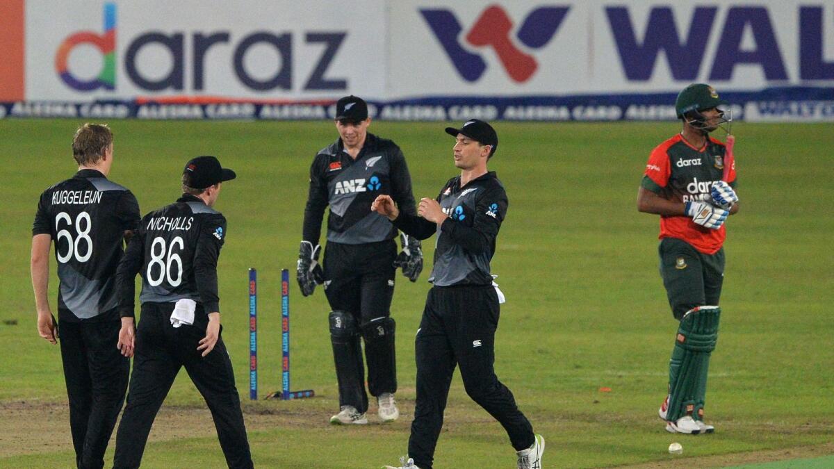 New Zealand's Scott Kuggeleijn (left) celebrates with teammates after taking the wicket of Bangladesh's Nasum Ahmed. — AFP