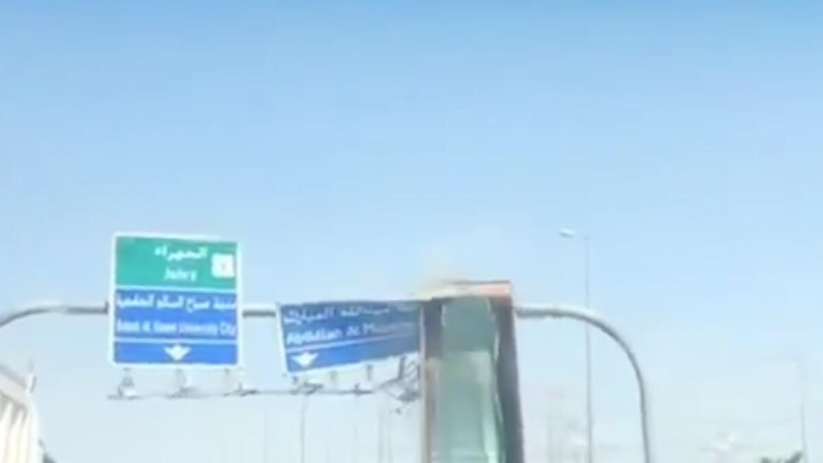 truck hits overhead road sign, dump truck, dumper, Kuwait