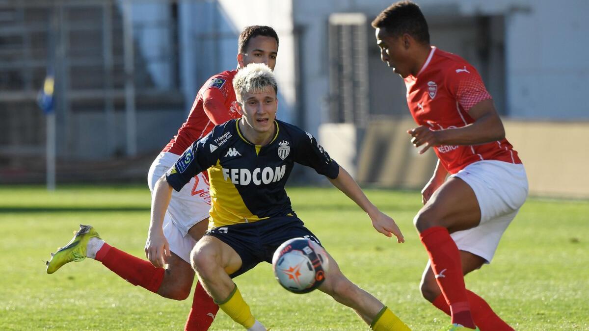 Monaco's Russian midfielder Aleksandr Golovin (centre) controls the ball during the French League match against Nimes. — AFP