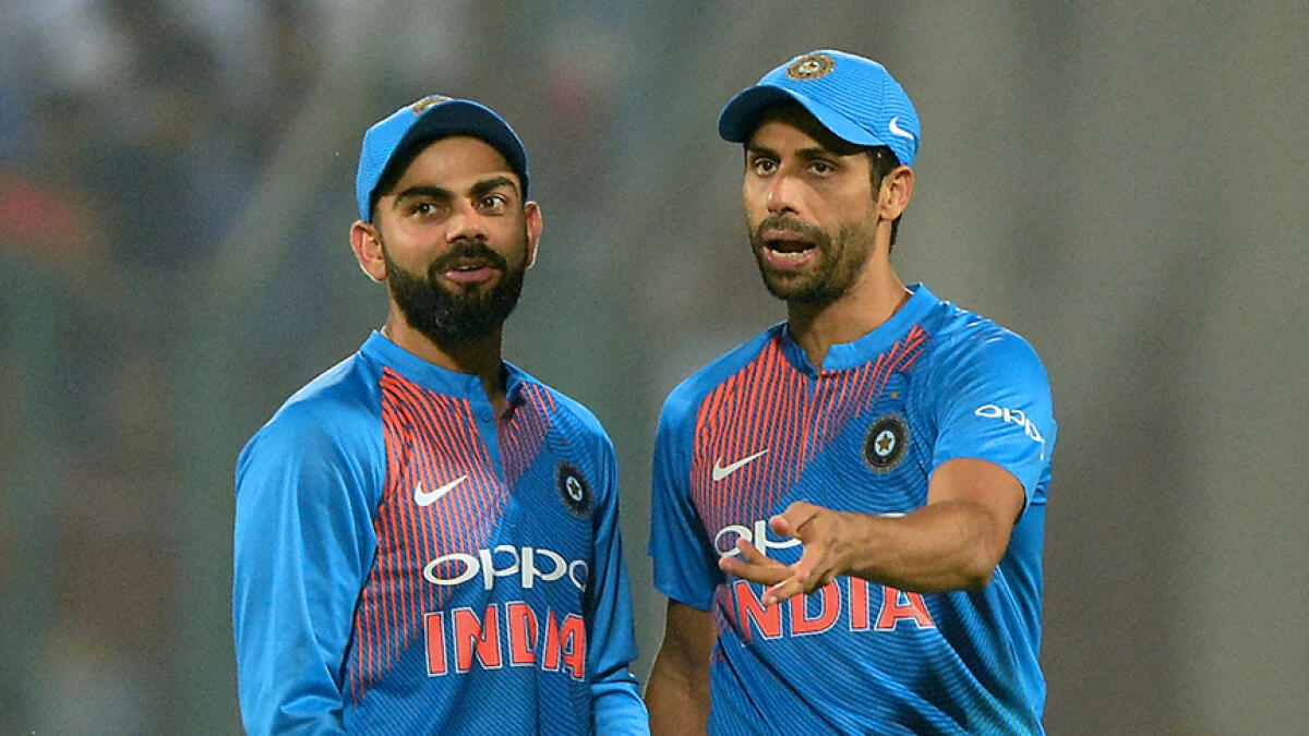 Former India medium-pacer Ashish Nehra (right) said he felt Kohli is a little bit impulsive captain. -- AFP