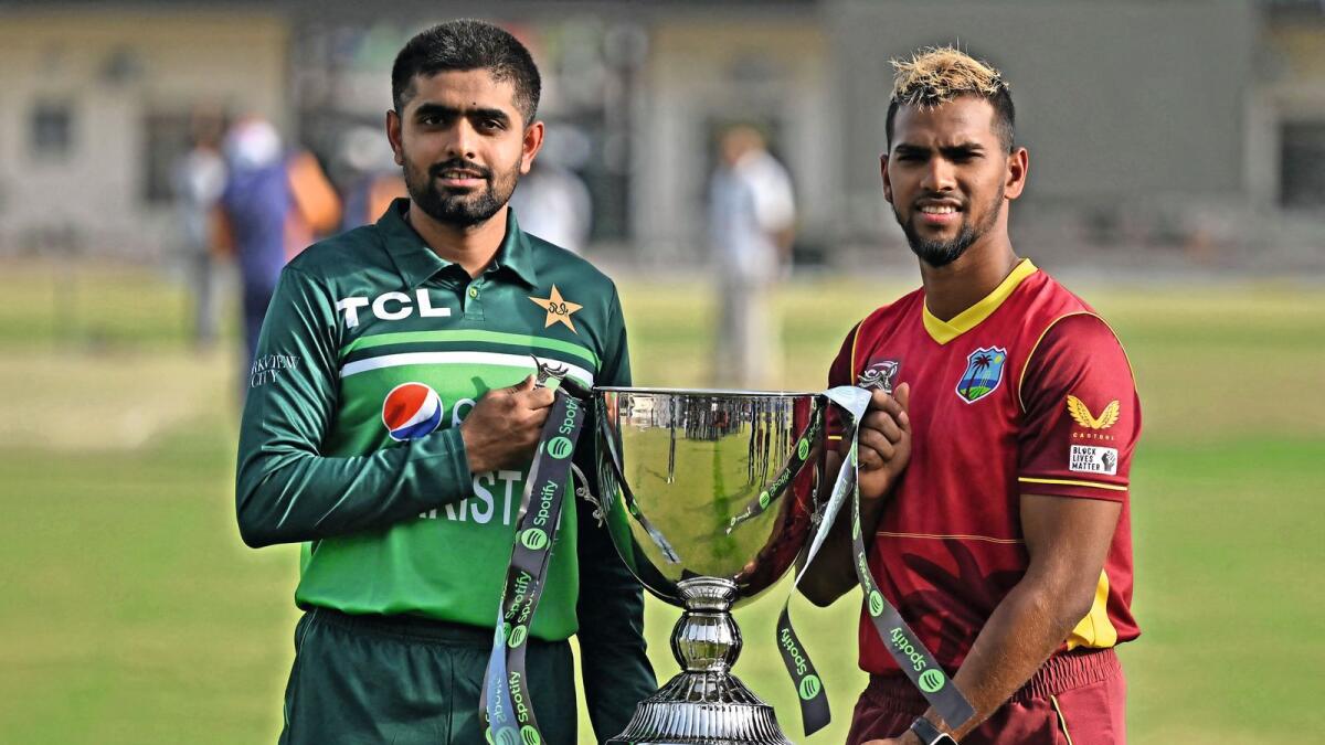 Pakistan captain Babar Azam (left) and West Indies skipper Nicholas Pooran pose with the trophy in Multan on Tuesday. — AFP