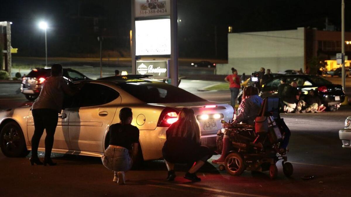 Car hits protester in Ferguson, shots ring out