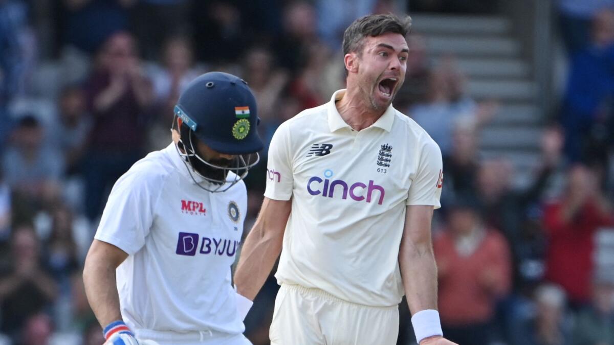 England's James Anderson (right) celebrates after taking the wicket of India's captain Virat Kohli on the first day of the third Test. (AFP)