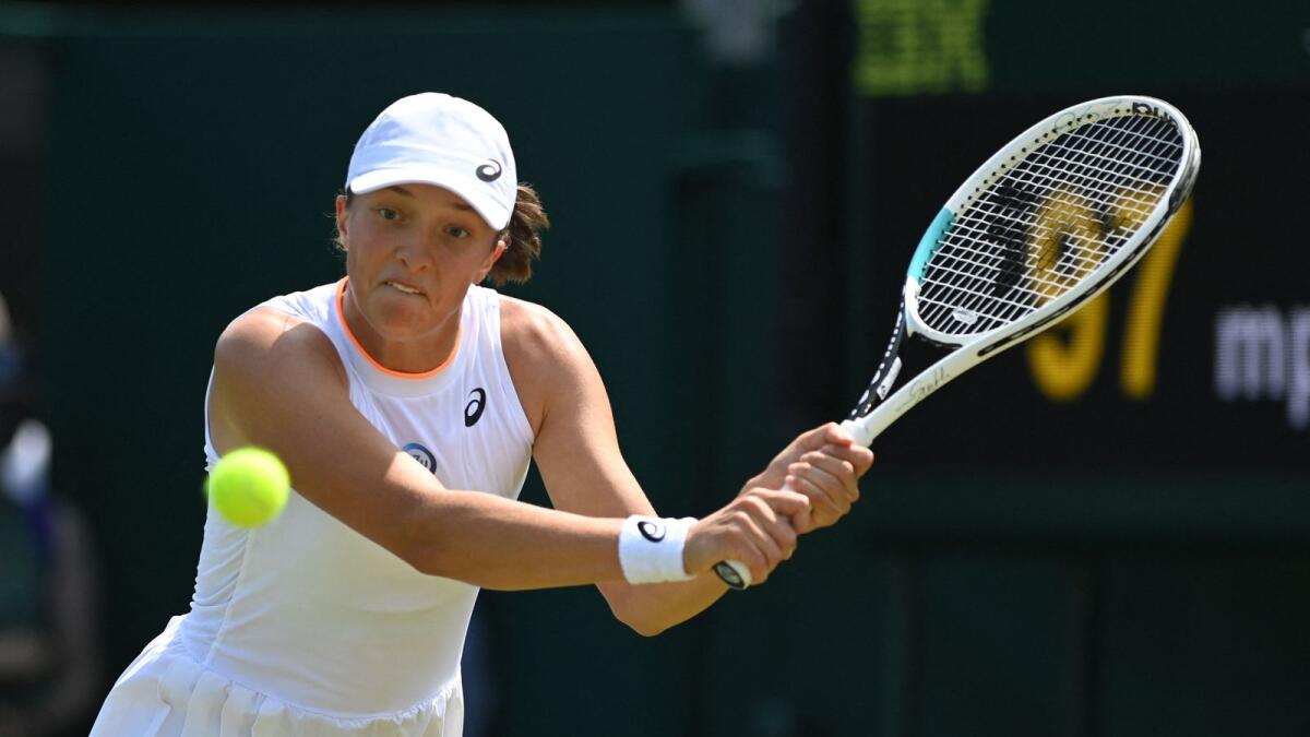 Poland's Iga Swiatek returns against Romania's Irina-Camelia Begu during their women's singles third round match on the fifth day of the 2021 Wimbledon Championships. — AFP