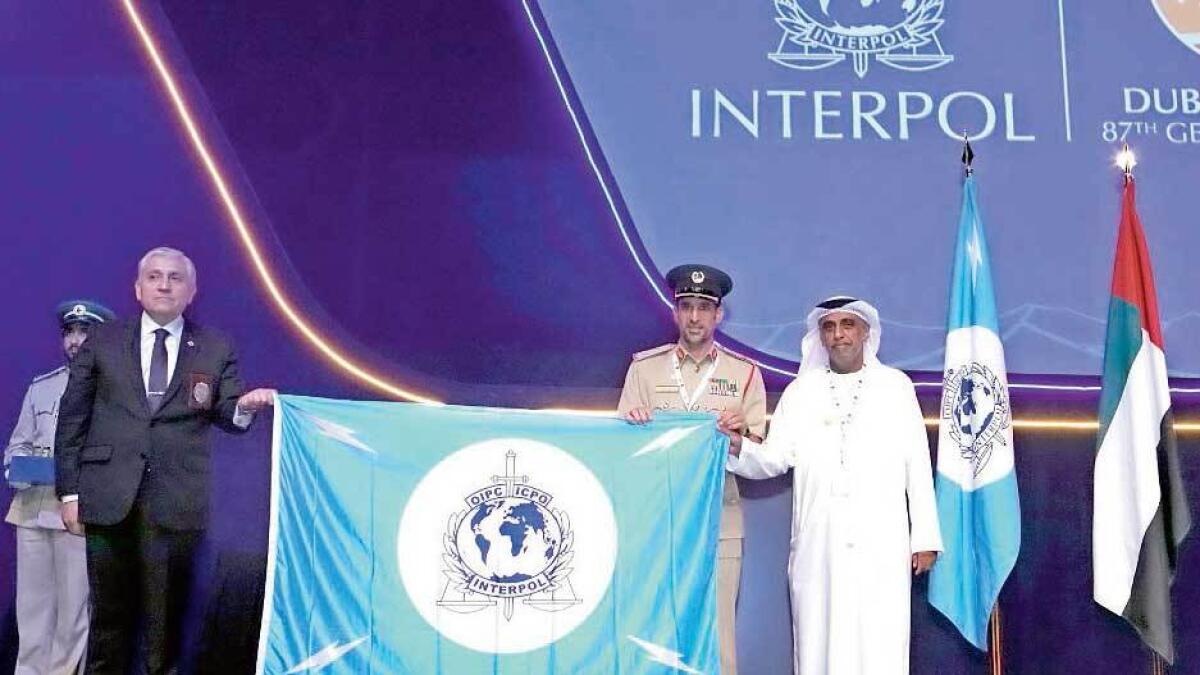 Héctor Espinosa Valenzuela receives the Interpol flag from Maj-Gen Abdullah Khalifa Al Marri in Dubai on Wednesday.