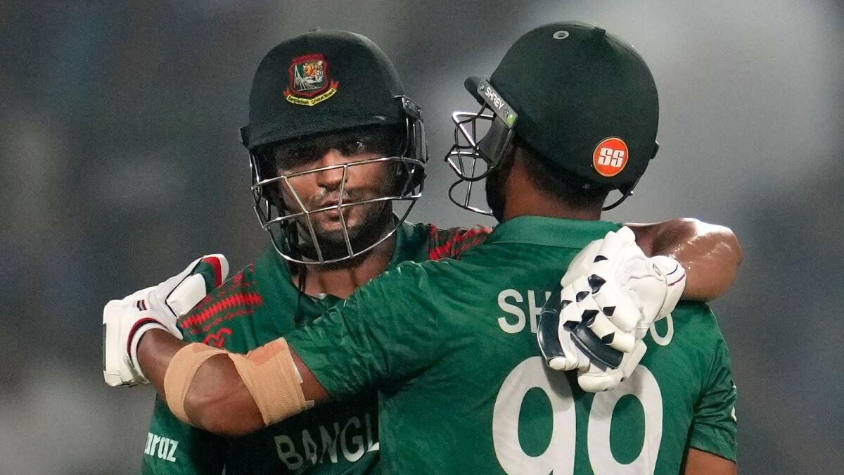 Bangladeshi batter Najmul Hossain Shanto being greeted by skipper Shakib Al Hasan as he celebrates scoringa  half century. - PTI